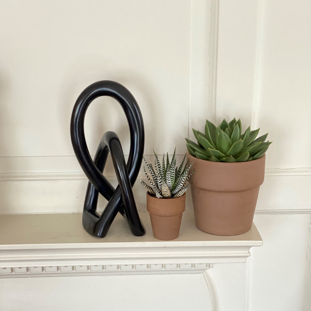 Jeffords Natural Soapstone Lovers Knot Sculpture Ivy Bronx Size: 6" H x 2.5" W x 2" D Finish: Black